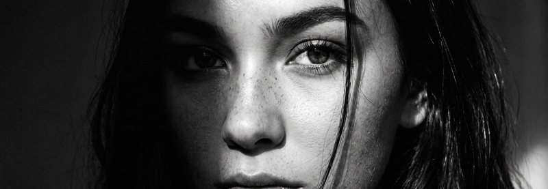 Nova Rai in black and white with her eyes on the camera, wide