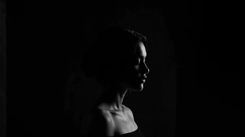 Nova Rai in a dark profile with only the edge of her face lit