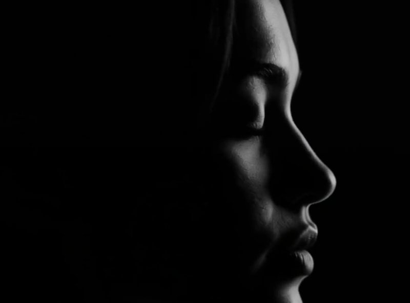 Nova Rai in profile in the dark, one light on her face